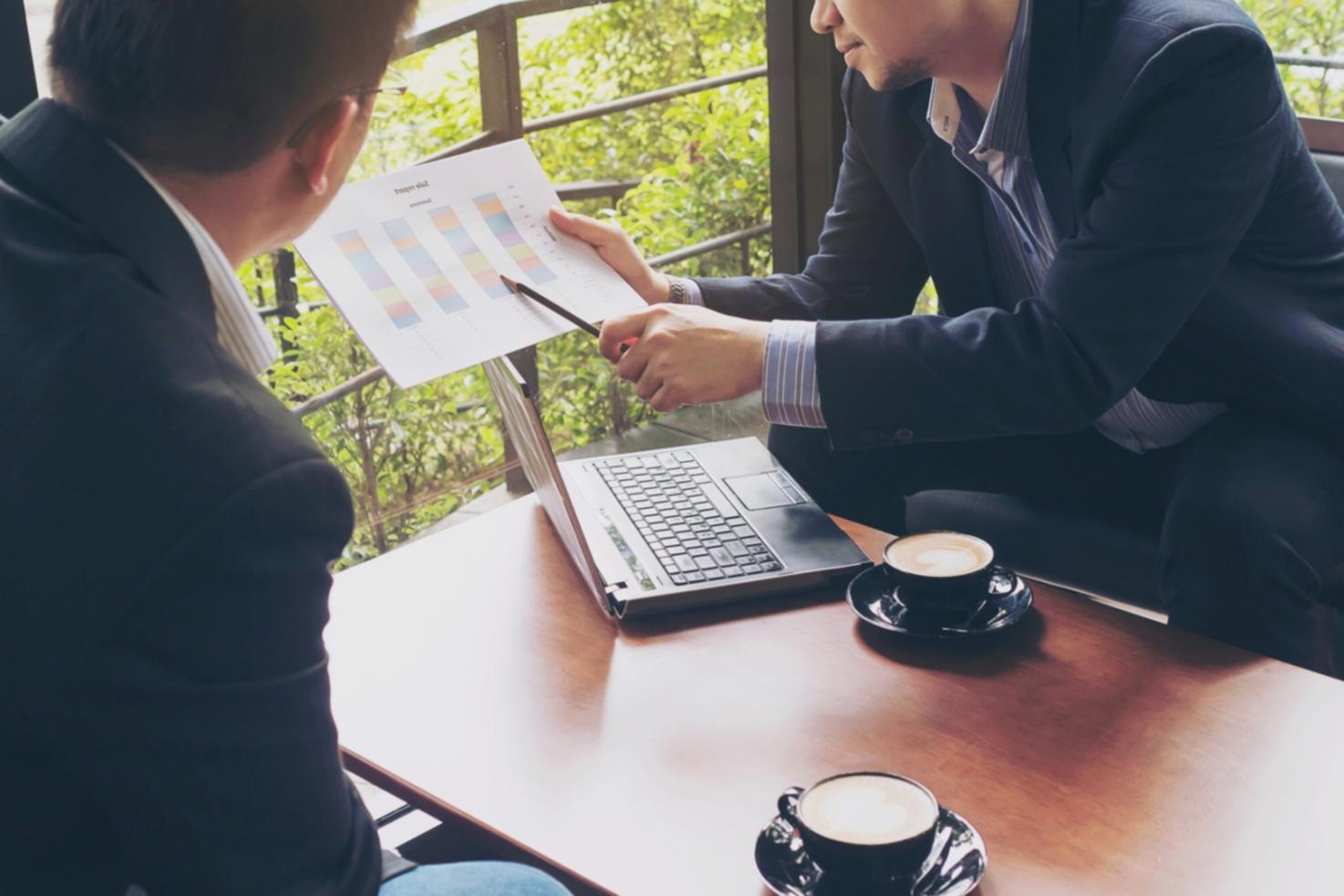 Modern business analysis workspace showing data visualization screens